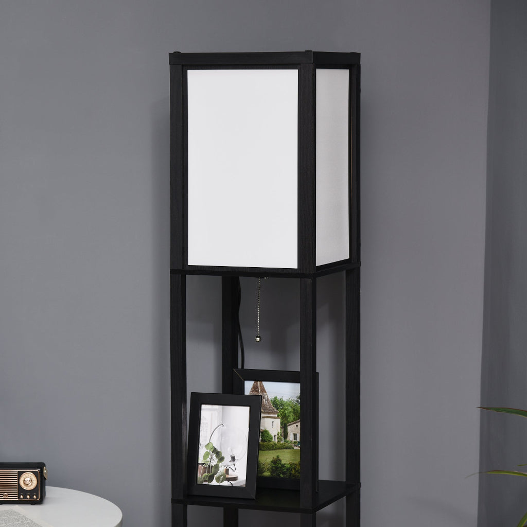 Black shelving unit with a white lampshade against a gray wall