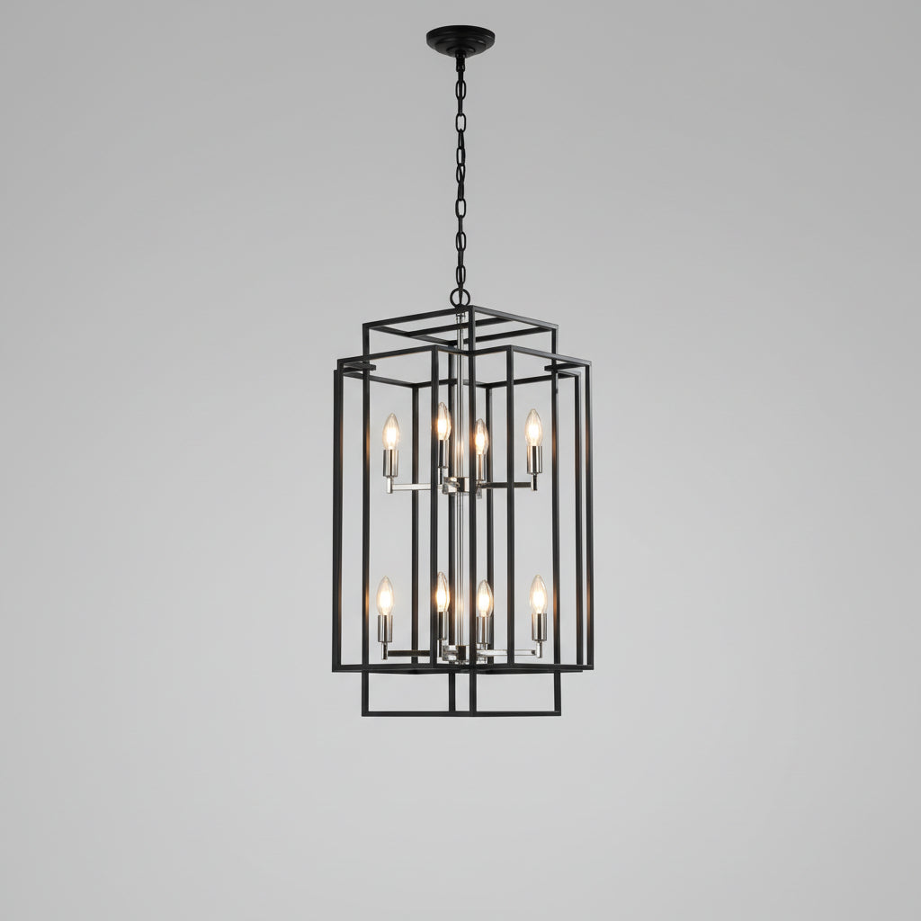 Foyer with a black chandelier, wooden side table, and abstract painting on the wall.