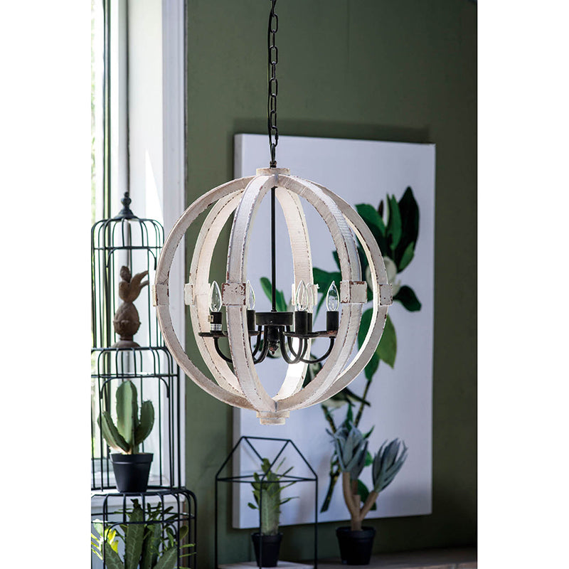 Decorative pendant light fixture in a room with plants and a painting on the wall.