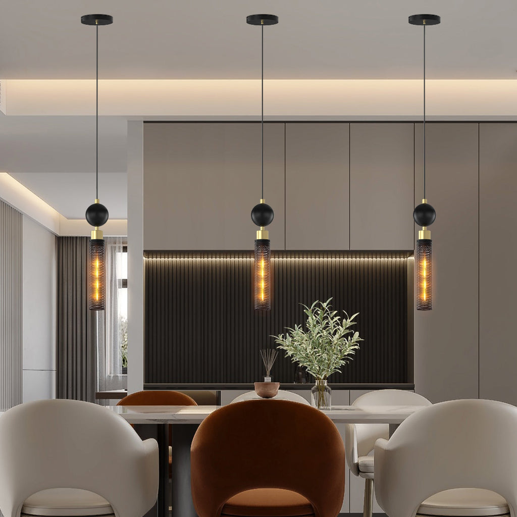 Modern interior design with pendant lights, a dining table, and chairs.