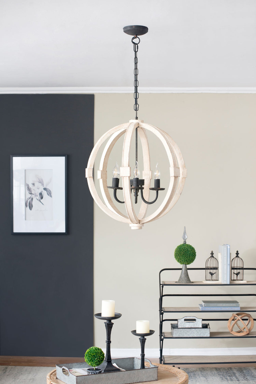 Modern chandelier hanging in a room with decor elements.