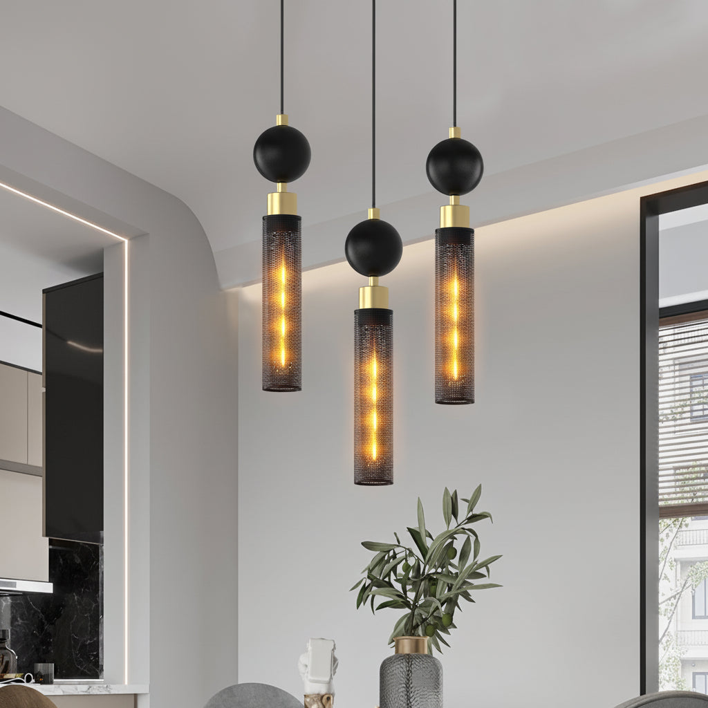 Modern pendant lights hanging in a room with a plant and window.