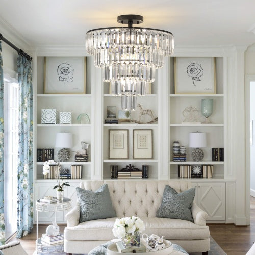 Living room with a chandelier, bookshelf, and sofa.